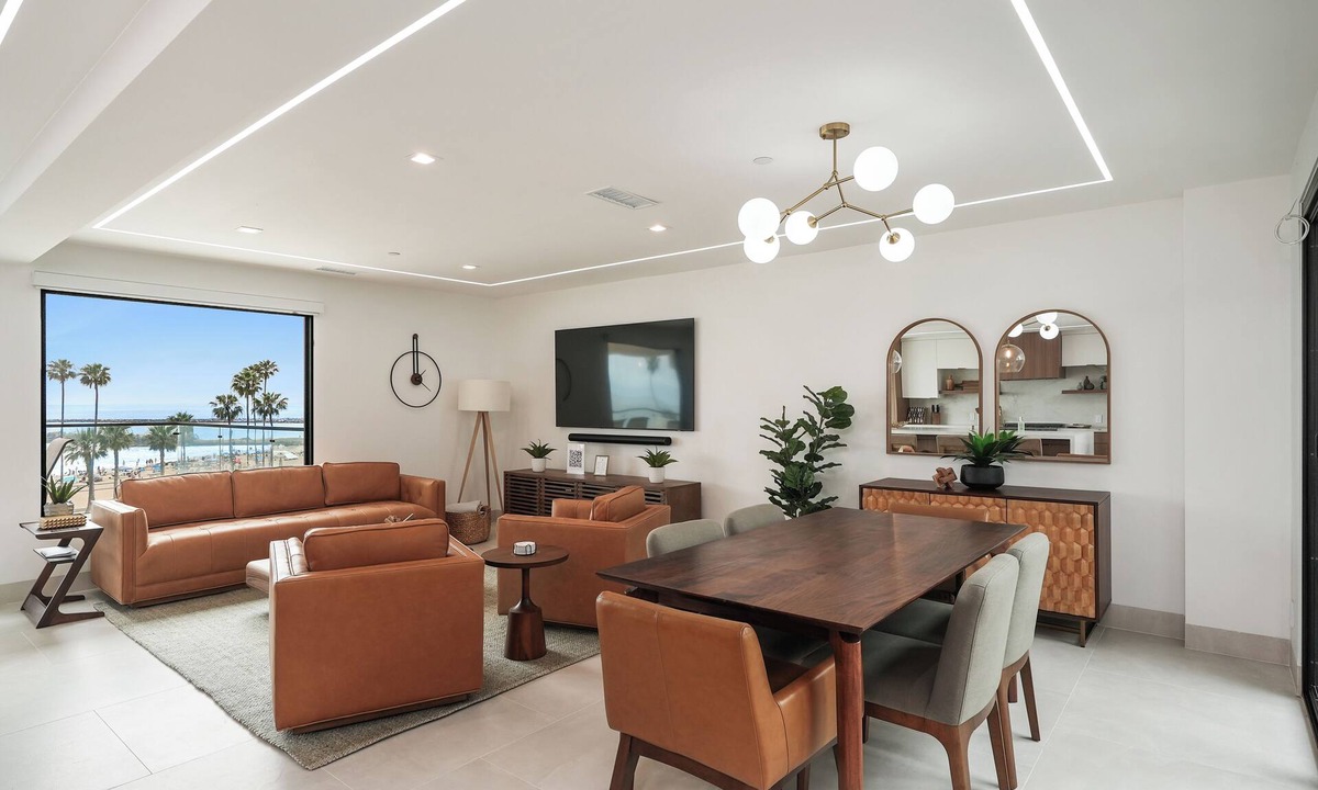 Corona del Mar Condo | Experience a luxurious 4-bedroom, 4.5-bath mid-century modern coastal escape in Corona Del Mar, CA. Steps from the Pacific Ocean, this fully remodeled home features a gourmet kitchen, private hot tub, sauna, and Cntrl4 system. Comfortably fits 10