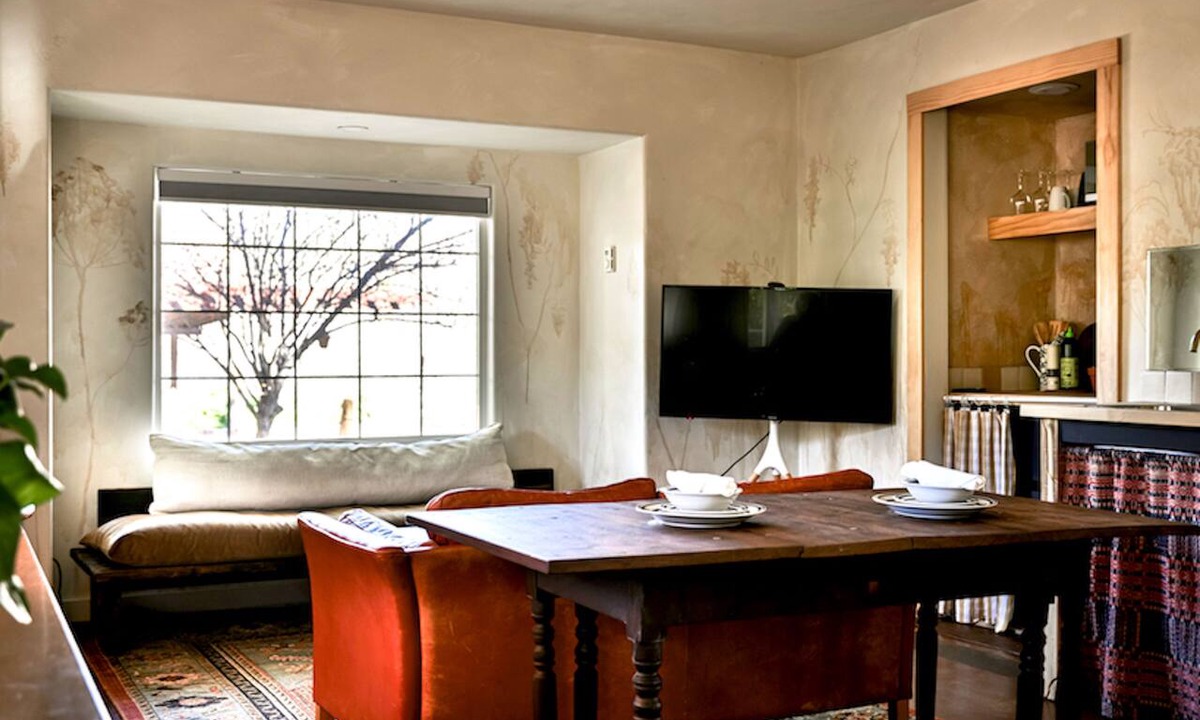 Cornville House | Tucked among pines on 1.3 dark-sky acres, this secluded king suite features a kitchenette, deep soaking tub, and patio with rocking chairs & grill. Stargaze beneath towering trees, explore lush gardens, and savor proximity to Page Springs vineyards.
