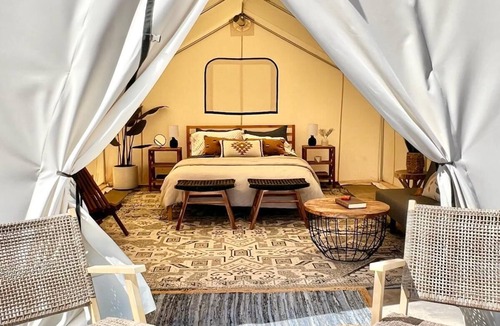 Utah House | Beautiful wall tent on sandy beach at waters edge