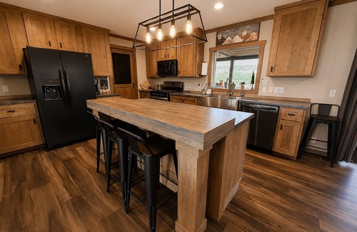 Marvel House | Riverfront Home with Hot Tub, AC, Large Deck