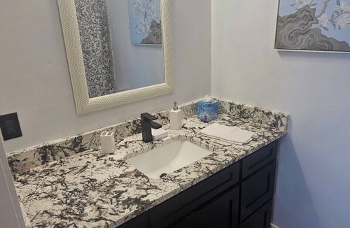 Duncan Apartment | Serene large bedroom with private entrance, bathroom, and thermostat.