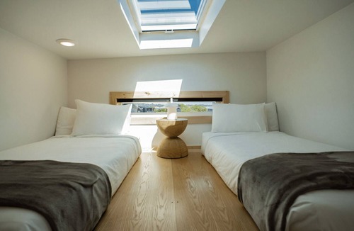 Coos Bay Cabin | Timber Haus w/Loft - Timber Haus, one of our newest (and largest) cabins, is full of light with full windows and skylights. Queen bedroom and upper two-twin loft. Sleeps 4.