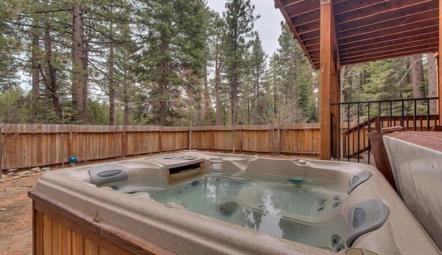 Enjoy the tree-lined yard, spacious deck, and hot tub!