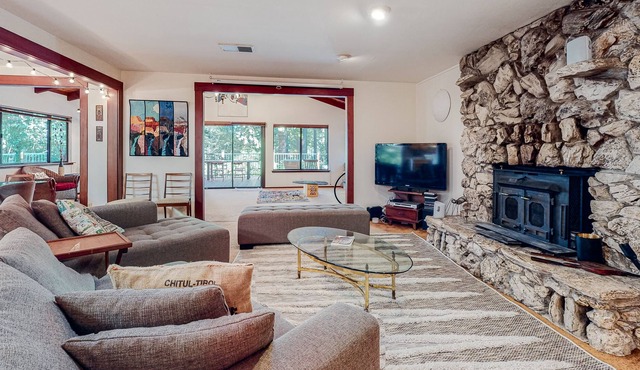 Forested home near the river with a hot tub, deck, playground, & washer/dryer