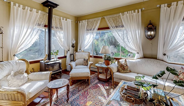 Gorgeous river view home with wood stove, sauna, patio, fitness room, & kitchen