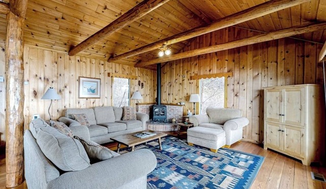Lakefront home with amazing mountain views, wraparound deck, fireplace, & grill