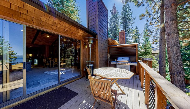 Lakeside condo with water views, private beach, dock, buoy, and wood fireplace