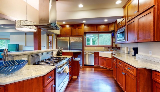 Lovely dwelling with riverfront views, large deck, grill, & patio seating