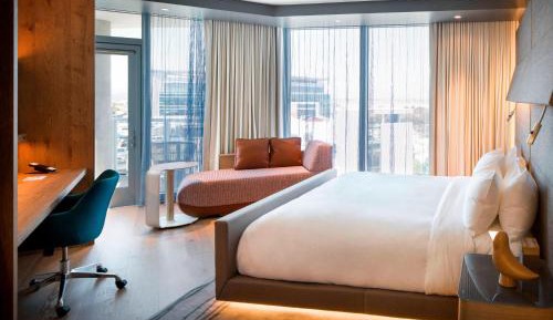 Corner King Guest Room with Balcony and Partial Bay View